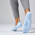 Feetures Elite Light Cushion Invisible no-show socks in Ice blue on model feet