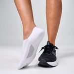 Feetures Elite Light Cushion Invisible white no-show socks worn with black ASICS running shoe