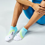 Feetures Elite Light Cushion Tab socks in Mint Chip colorway worn by seated model