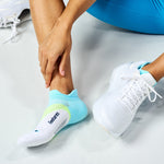 Feetures Elite Light Cushion Tab sock in Mint Chip colorway worn with white athletic sneaker