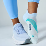Feetures Elite Light Cushion Tab socks in Mint Chip worn with light blue sneakers