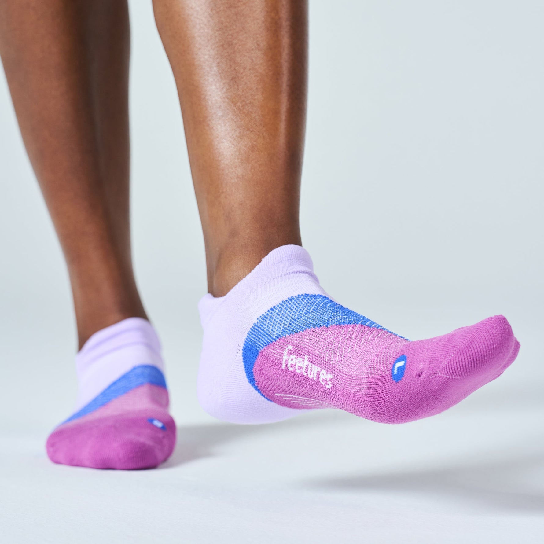 Feetures Elite Light Cushion Tab socks in Lilac Breeze with blue and pink accents on model