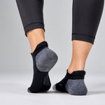Feetures Elite Max Cushion Tab socks in black with gray cushioned areas on feet