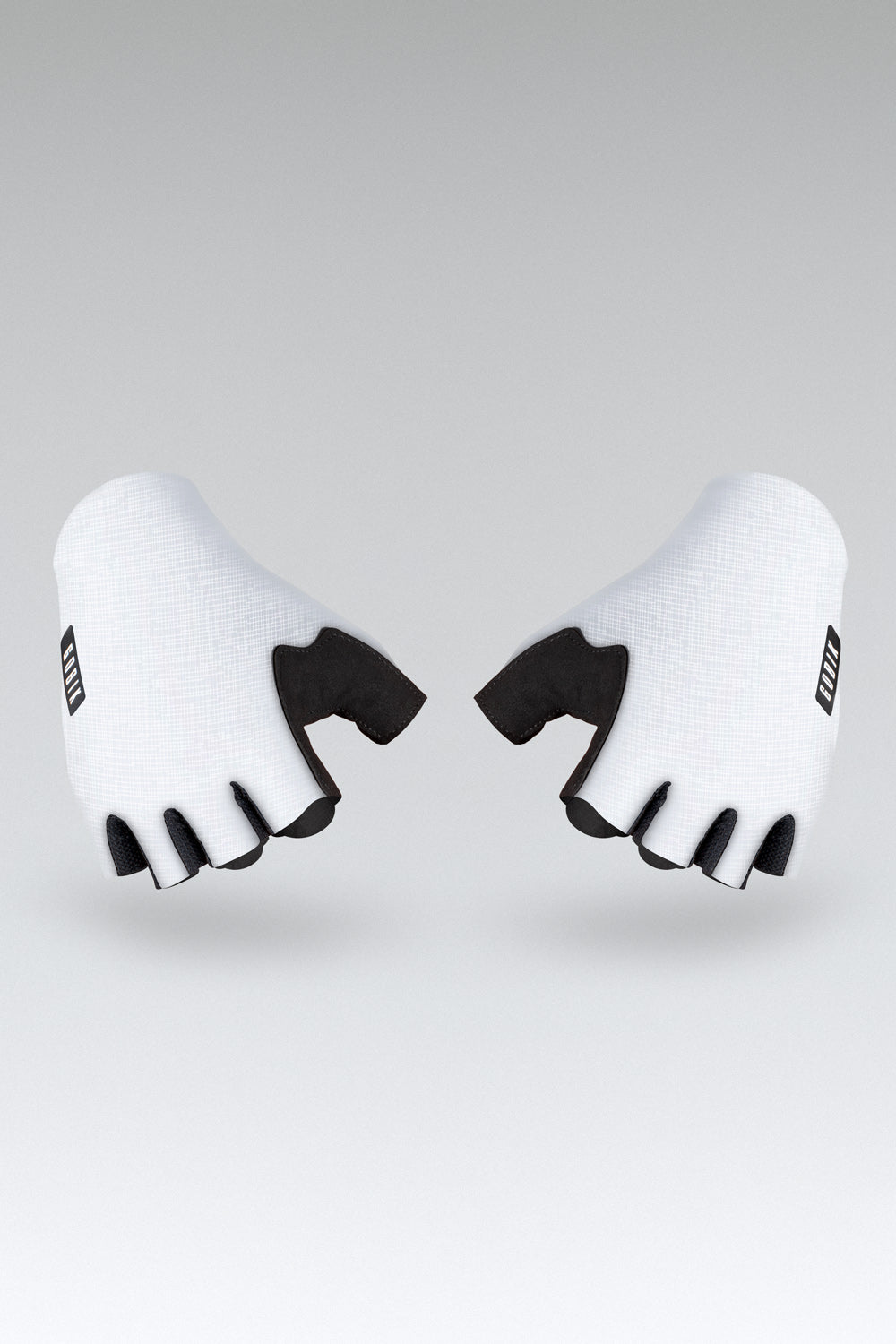 White cycling gloves with black palm grip and finger cutouts on gray background