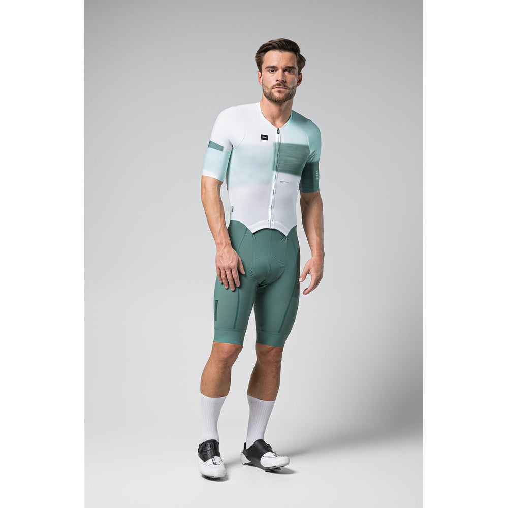Male cyclist wearing Gobik Brooklyn Aerosuit in white and green gradient colorway