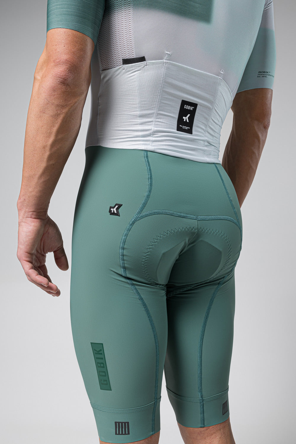Gobik cycling suit in emerald green with white panel, professional studio photography