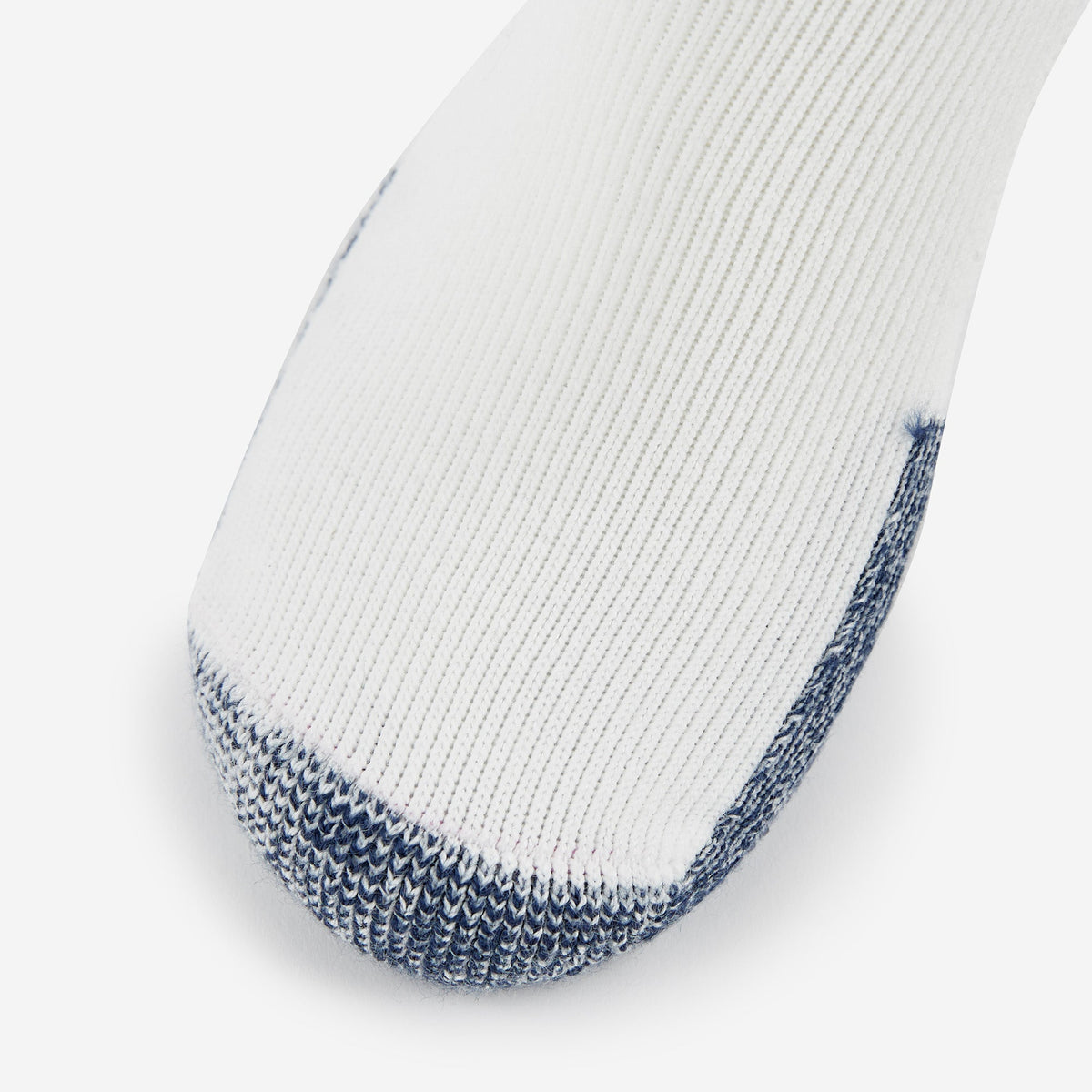Thorlo thick cushion running sock in white with navy blue toe and heel detail