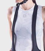 Woman wearing white checkered cycling bibshorts with black shoulder straps