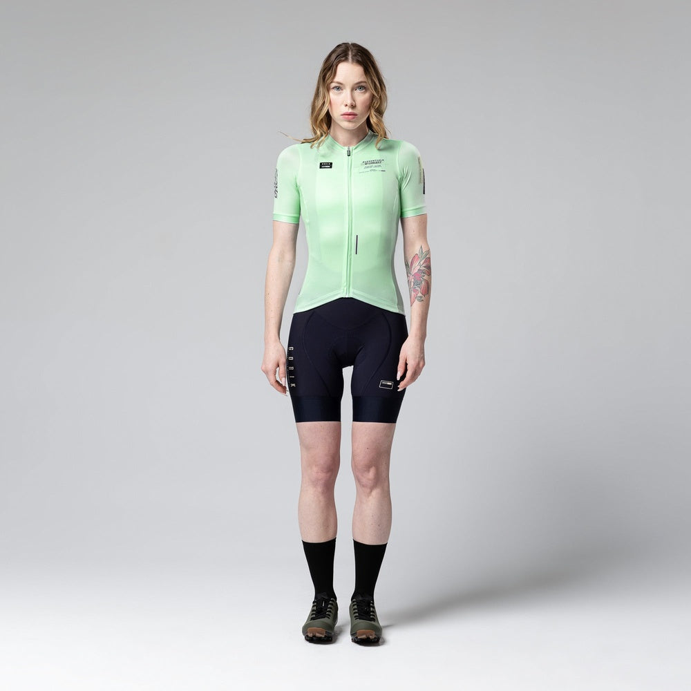 Woman wearing Gobik Stark short sleeve cycling jersey in seamint green with black shorts