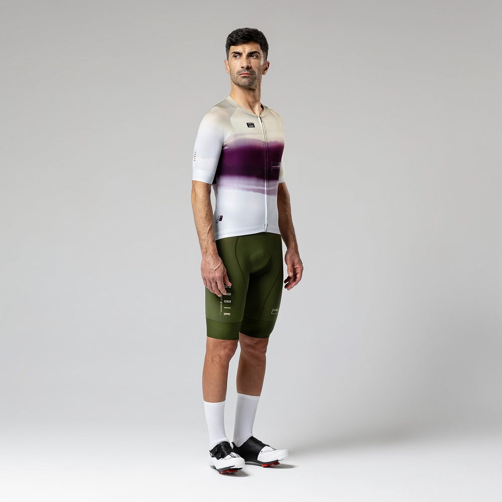 Male cyclist wearing Gobik CX-Pro jersey in Teaberry colorway with olive bib shorts