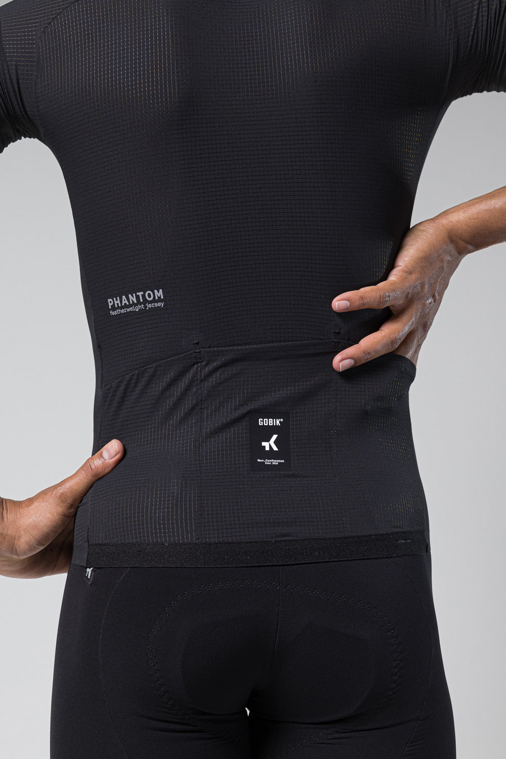 Gobik Phantom featherweight cycling jersey in black with professional studio lighting