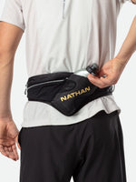 Nathan Peak Hydration Waist Pack in black worn around waist with water bottle