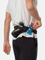 Nathan Peak Hydration Waist Pack in black with gold accents worn around waist