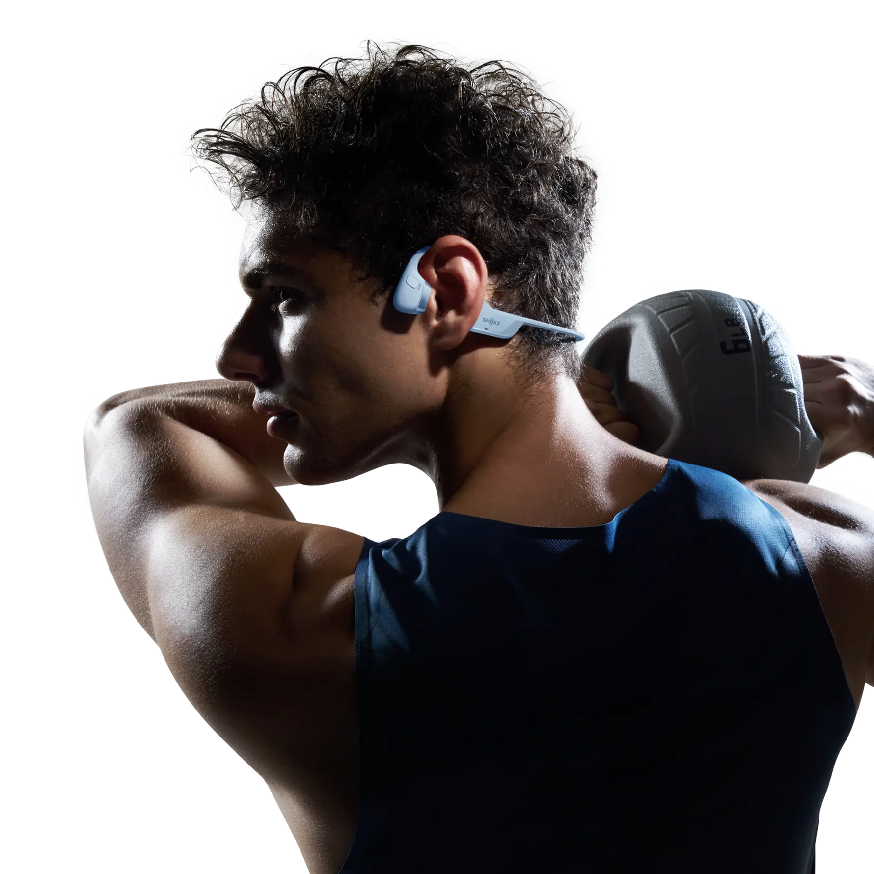 Athlete wearing blue Shokz OpenRun PRO 2 bone conduction headphones during workout
