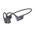 Gray Shokz bone conduction headphones with wraparound design on white background