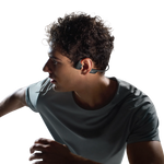 Young man wearing black Shokz OpenRun Pro 2 bone conduction headphones while exercising