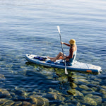 Woman paddling Retrospec Weekender Plus inflatable SUP kayak hybrid on calm clear water