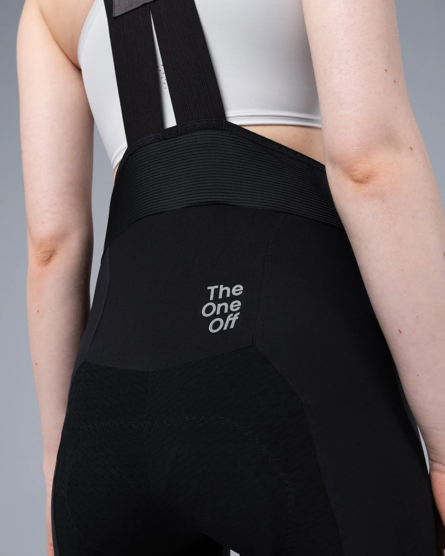 TheOneOff Xenon Bib Short in black shown from rear on female model