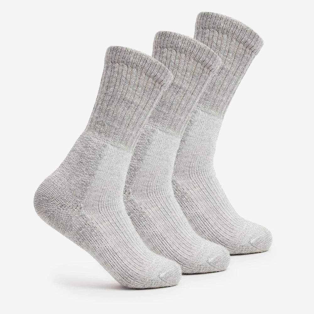Three Thorlos light grey wool blend trekking crew socks with cushioned sole displayed upright