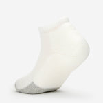 Thorlos white low cut tennis sock with gray heel cushioning on clean background