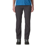 Woman wearing dark gray Patagonia Quandary pants with blue top and hiking shoes