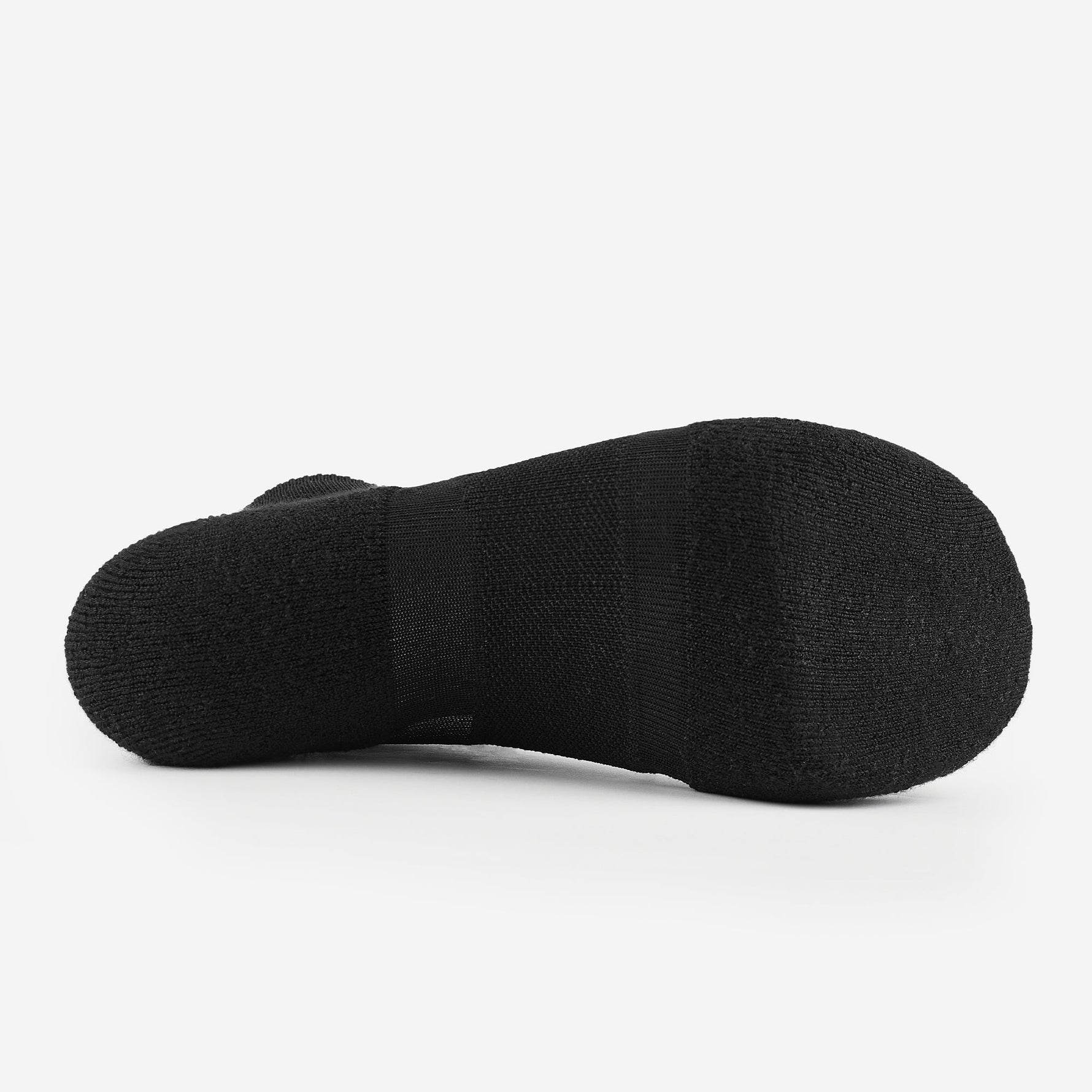 Bottom sole view of black Experia Light Cushion Low-Cut Socks showing textured knit construction