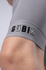 Close-up of gray Gobik bib shorts showing brand name on leg band