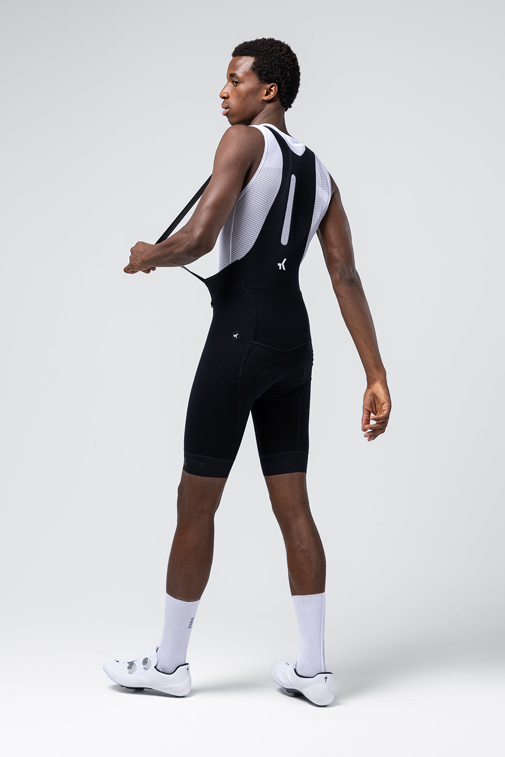 Man wearing black Gobik cycling bib shorts with white mesh base layer