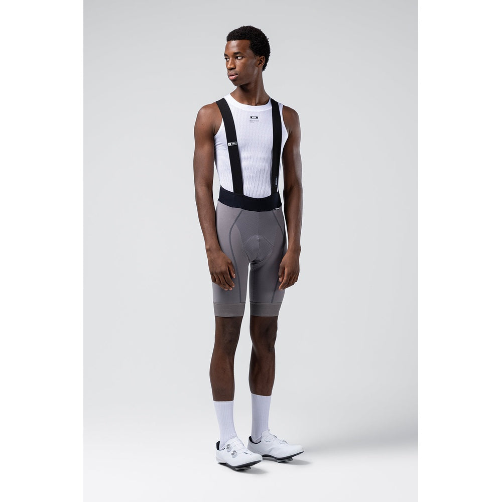 Male model wearing Gobik Absolute Compact bib shorts in gray Kettle with white base layer, front view