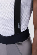 Detail view of Gobik Absolute Compact bib short waistband and suspender junction with Compact label tag