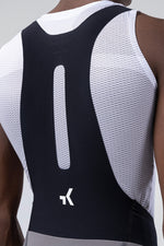 Close-up detail of Gobik bib straps showing mesh back panel and brand logo on male model