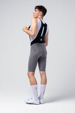 Male cyclist wearing Gobik X bib shorts in kettle gray color with white cycling jersey