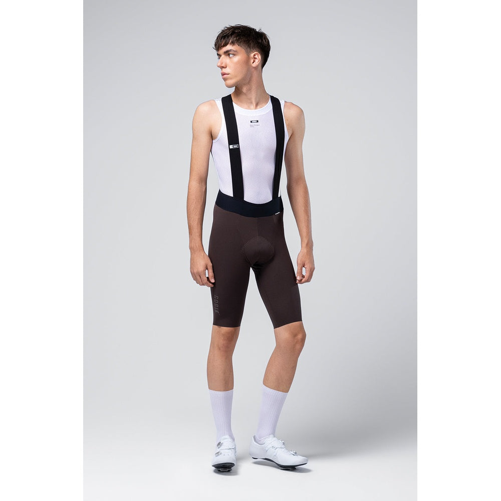 Male cyclist wearing black Gobik X bib shorts with white jersey and socks