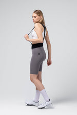 Woman wearing Gobik X Bib Short in gray against clean studio background