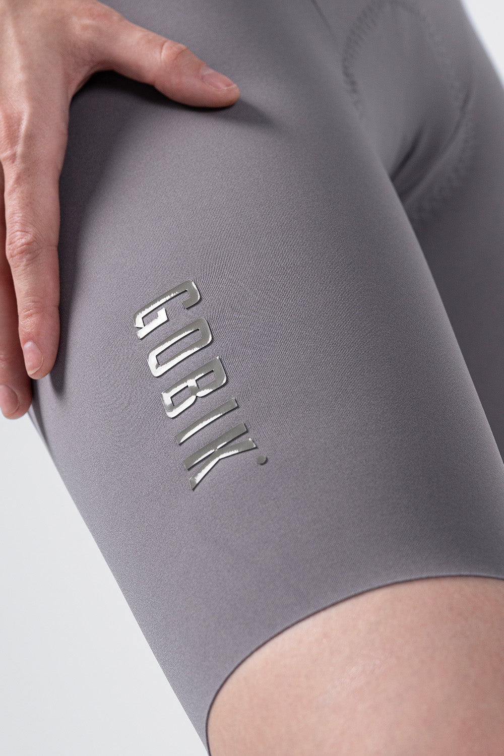 Gobik women's gray cycling bib shorts with reflective logo detail