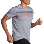 Man wearing gray Brooks Distance Graphic T-Shirt with striped RUN USA design