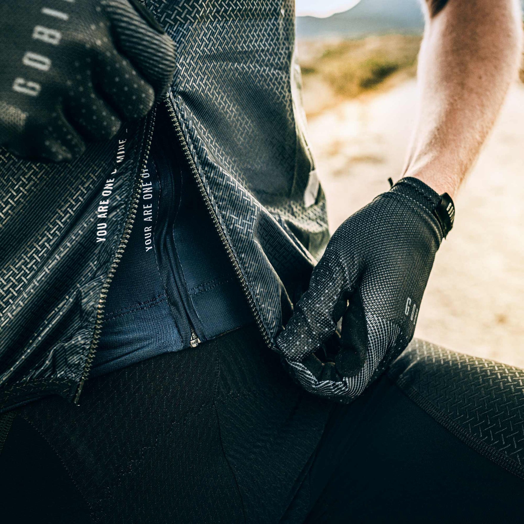 Gobik Vest Plus 2.0 Men's in Citizen colorway showing black textured fabric and brand details