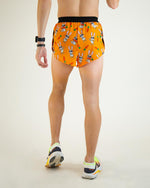 Back view of ChicknLegs 2-inch DS Split Shorts in orange Bad Bunny pattern with running shoes