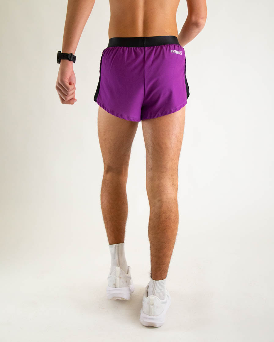 Back view of man wearing purple running shorts with black waistband and side panels