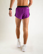 Man wearing purple running shorts with black waistband and side panels