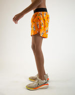 ChicknLegs 4-inch half split running shorts in orange Bad Bunny print pattern