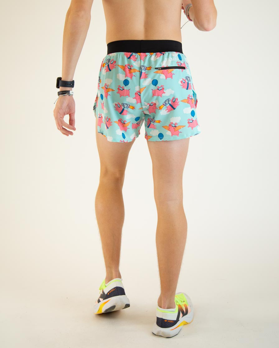 Man wearing light blue running shorts with colorful flying pig print pattern