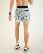 Man wearing light blue running shorts with flying pig pattern, back view