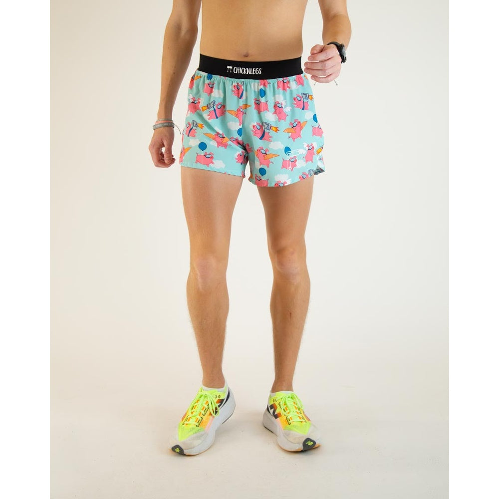 Man wearing ChicknLegs turquoise flying pigs pattern running shorts with black waistband