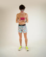 Man wearing ChicknLegs flying pigs pattern running shorts in light blue
