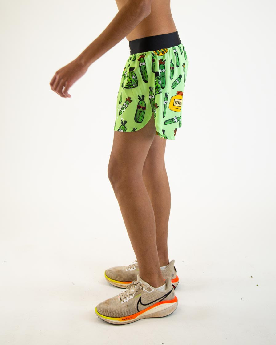 Man wearing bright green ChicknLegs running shorts with pickle print pattern