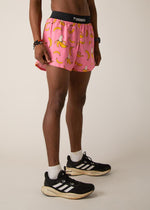 Man wearing pink running shorts with yellow banana print and black waistband
