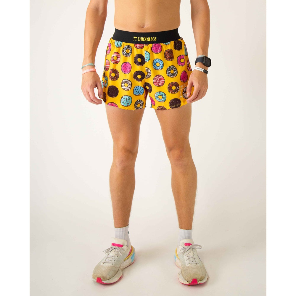 ChicknLegs men's yellow shorts with colorful donut pattern, modeled on legs
