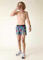 Man wearing ChicknLegs gray shorts with colorful porta potty print pattern