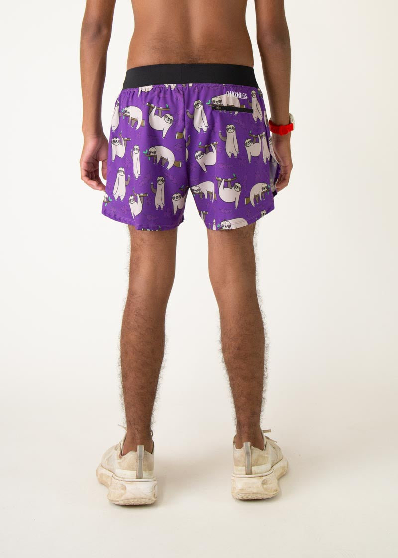 Purple men's running shorts with cute sloth print pattern, worn by male model